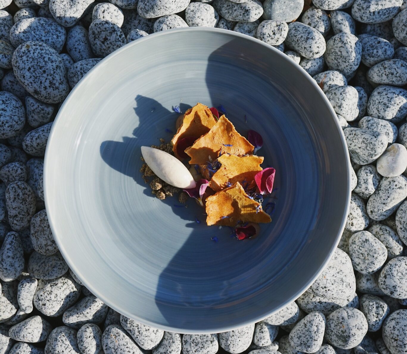 Dessert plated in bowl on pebbles
