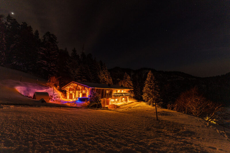 Austrian mountain home lit up at night
