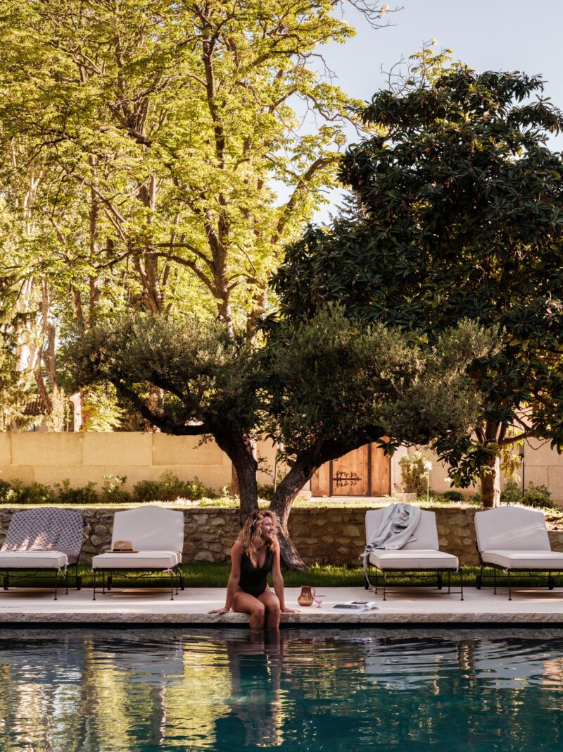 Lady relaxing by swimming pool of provencal luxury home to rent