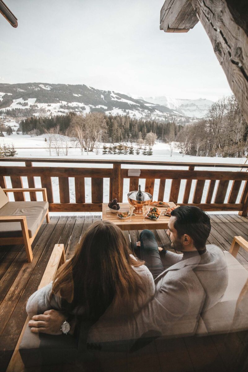 romantic chalet in Megeve with couple by a fire