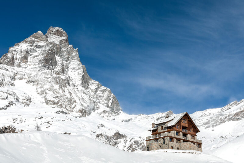 luxury italian ski chalet in snow with matterhorn behind