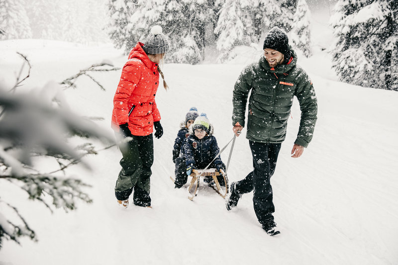 Family time in Lech Austria pulling children on a sled