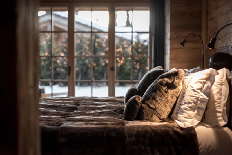 bedroom in luxury chalet in Gstaad looking out onto snow