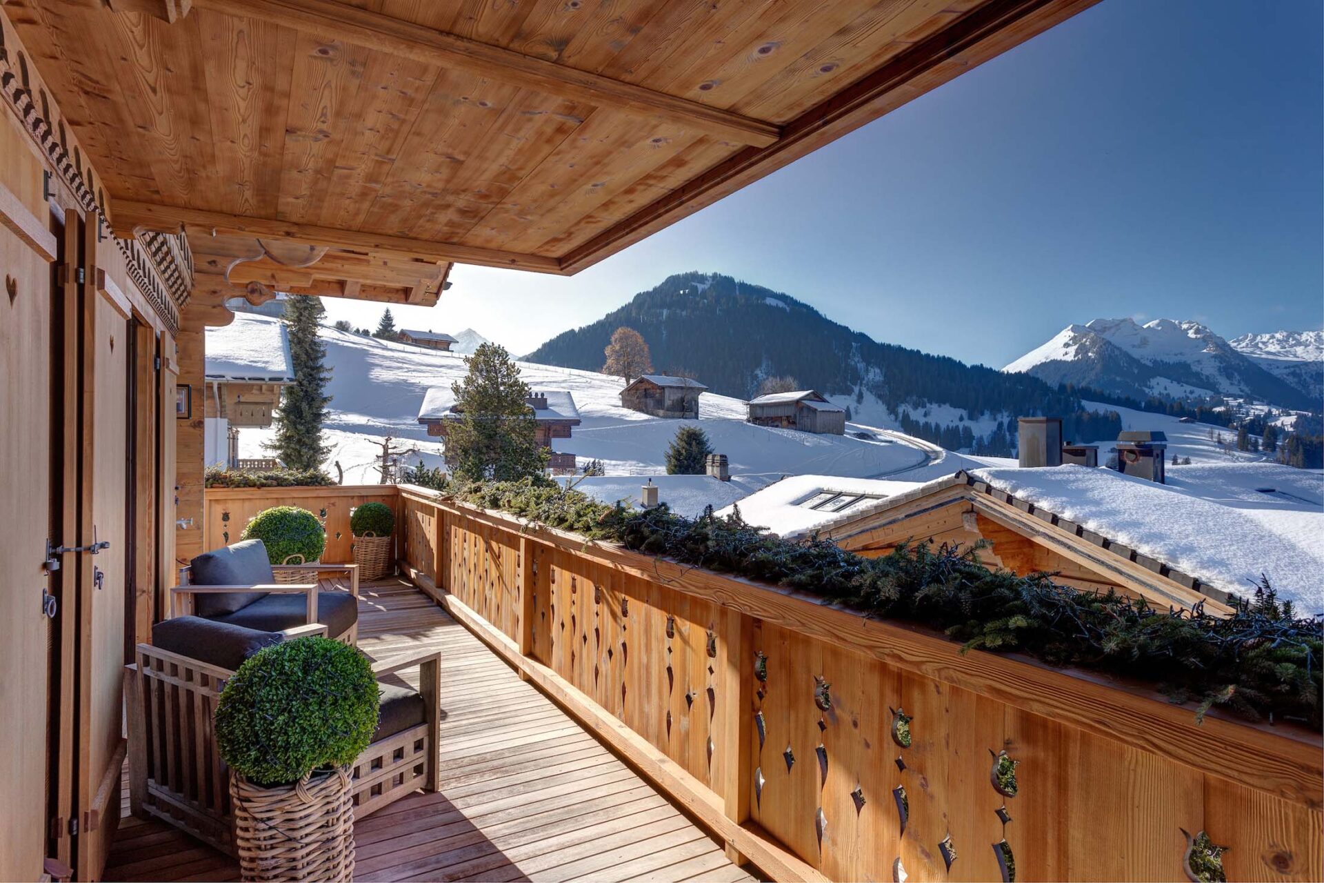 Luxury chalet view over Gstaad with mountains of snow