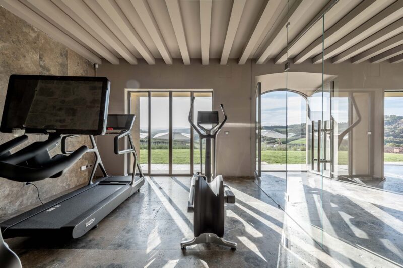 gym looking out of window of private luxury villa in Tuscany