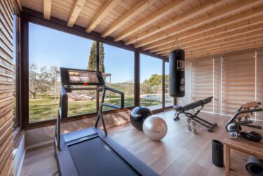 Gym in villa in Tuscany looking out to olive groves