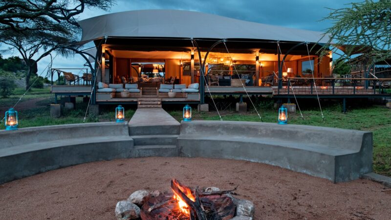 Serengeti lodge with fire pit at night